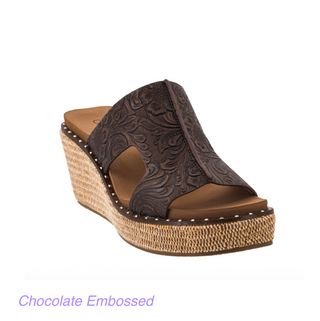 A women's wedge slide sandal in dark chocolate brown embossed leather with cutout sides, shown on a white background with the text 'Chocolate Embossed' below.