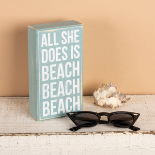 All She Does Is Beach box sign angled view