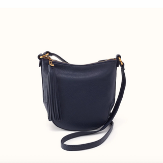 A navy blue pebbled leather crossbody bag with a tassel zipper pull and gold-tone hardware, shown on a clean off-white background.