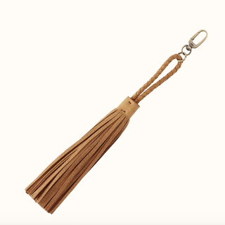 A tan leather tassel keychain with a braided rope handle and a brass carabiner clip, shown on a plain white background.