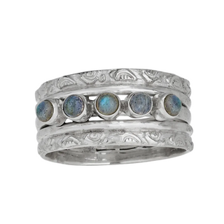 Silver ring with embedded stones on a white background