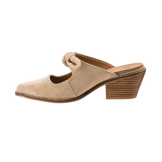 A single women's mule sandal in light beige suede, featuring a low stacked wood-look heel and a knotted strap detail on the vamp, shown against a plain white background.