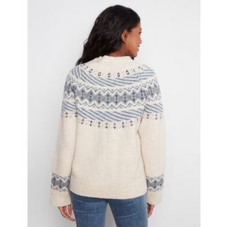 A woman shown from the back wearing a cream-colored knit sweater with a blue and gray Fair Isle pattern across the shoulders and sleeves, paired with blue jeans against a light gray background.