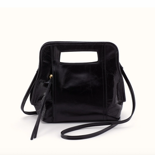 A black glossy faux-leather handbag with a rectangular top handle cutout and a thin shoulder strap, photographed on a clean white background.