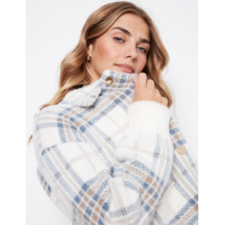 A woman wearing a fuzzy white plaid coat with blue and beige stripes, featuring a high collar with buttons and soft white trim.