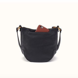 A black pebbled leather crescent-shaped shoulder bag with gold-tone hardware, shown on a clean off-white background. A brown leather phone is partially tucked into the top pocket.