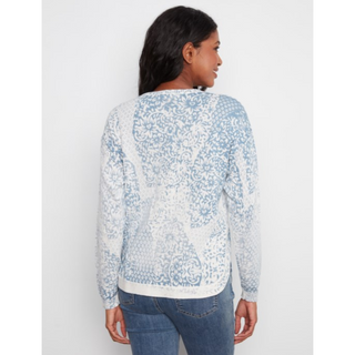 A woman shown from the back wearing a light blue and white patterned long-sleeve top with blue jeans, set against a plain light gray studio background.