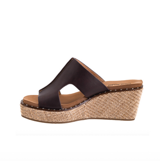 A women's wedge sandal shown in side profile on a plain white background. The upper is made of dark brown leather with a cutout design, and the wedge heel and platform are wrapped in a natural tan jute weave.