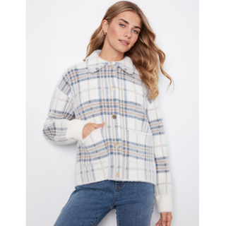 A woman wearing a white plaid jacket with blue and beige stripes, featuring collar and cuffs, paired with blue jeans against a plain white background.