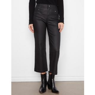 Black cropped flare pants with a high waist and front button closure, shown on a model wearing a black ribbed top and black ankle boots against a white wall.