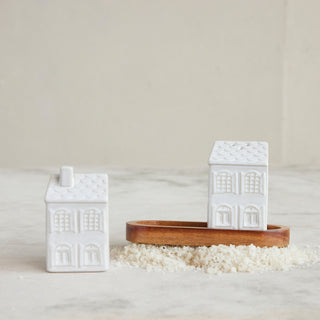Stoneware house salt and pepper shakers styled on a table